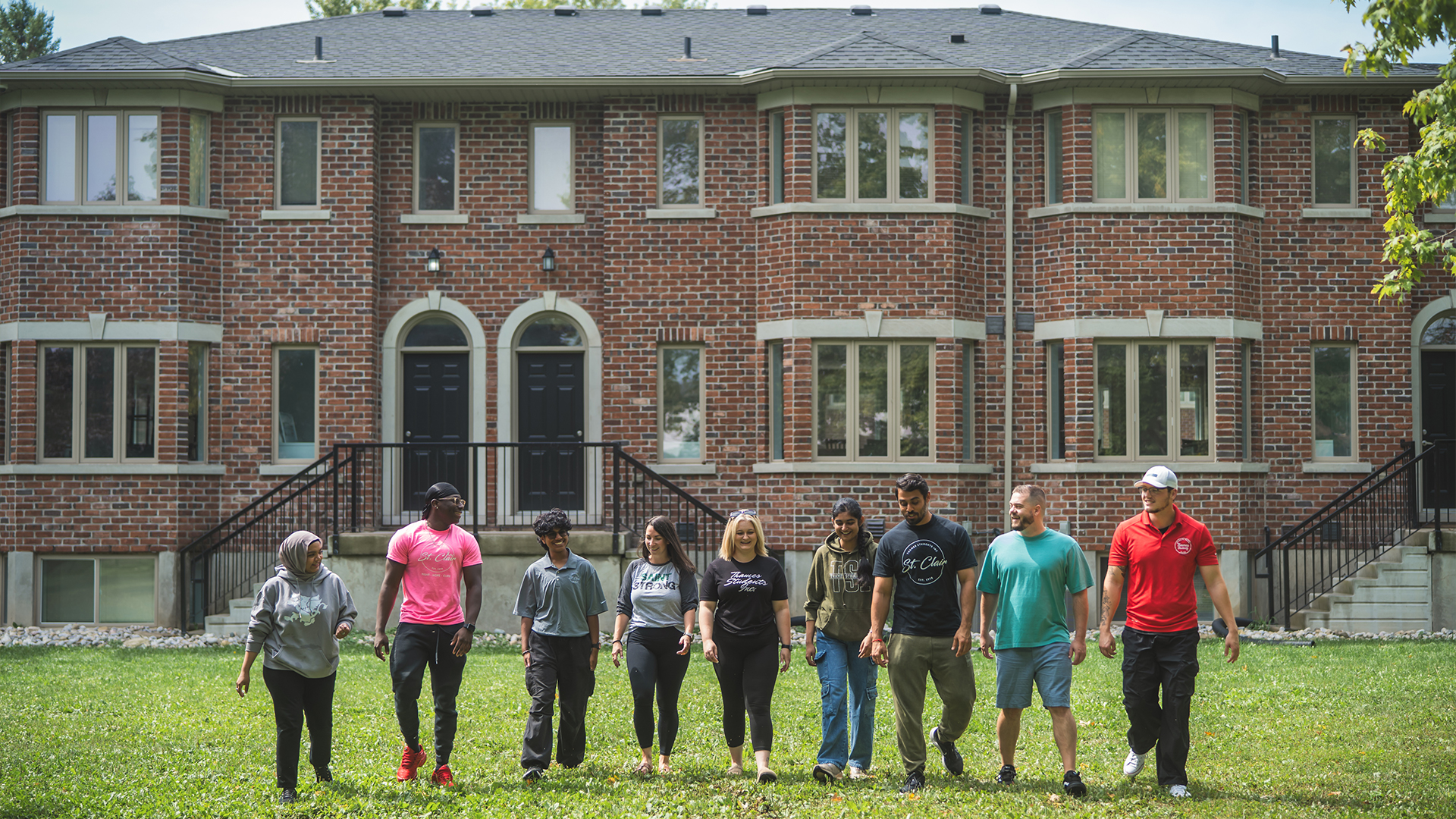 TSI members walking in front of residence