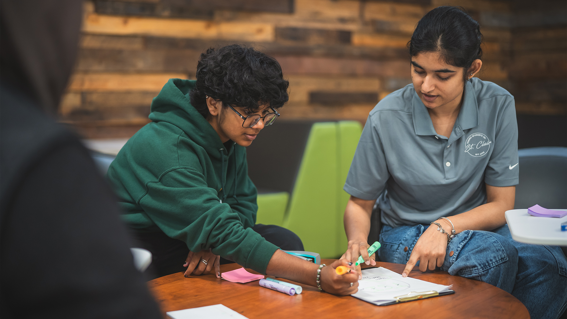 One student helping another with homework